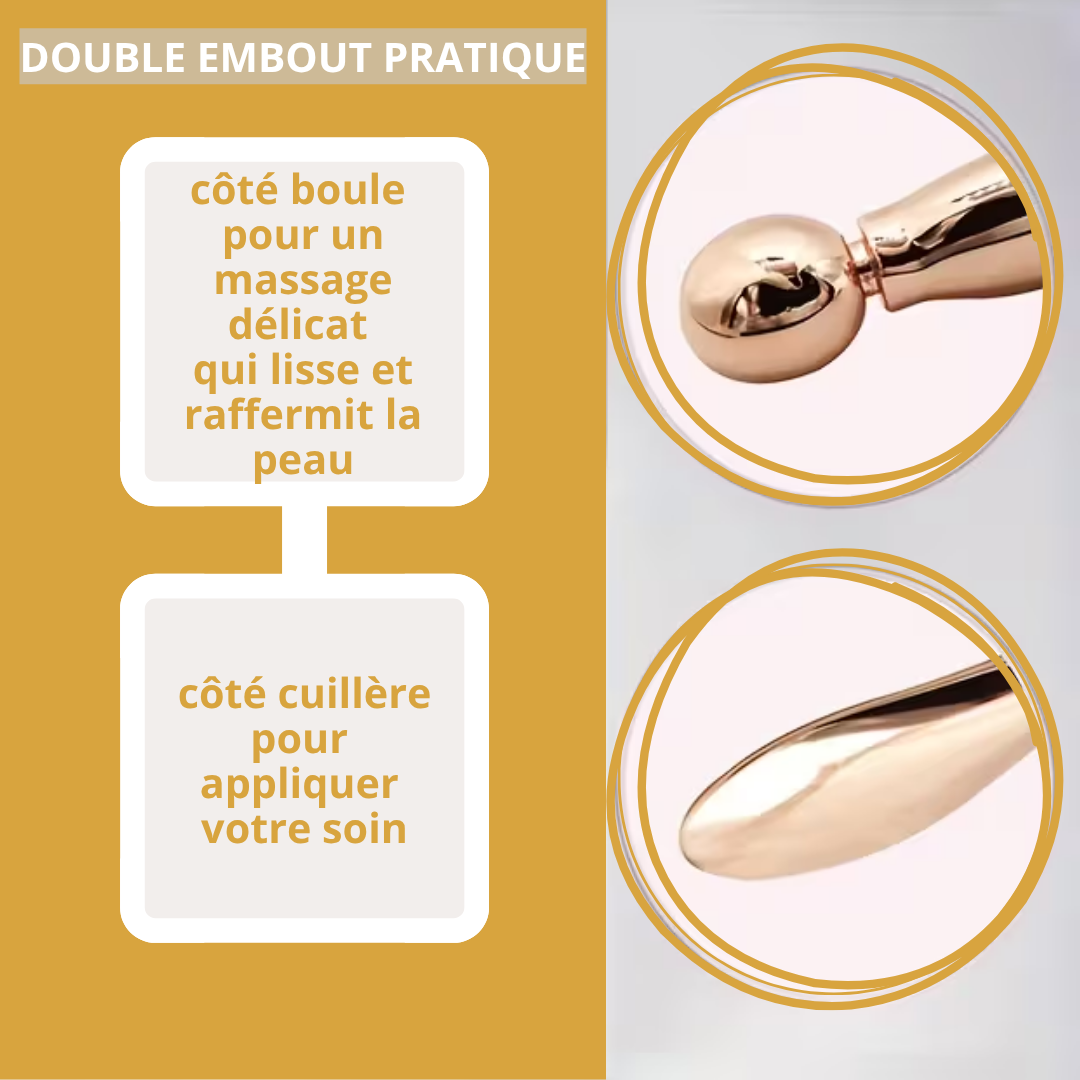 Gros plan sur le masseur doré à double tête : cuillère d’application et boule de massage